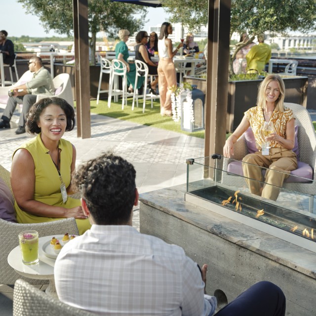 group chatting on rooftop overlooking river