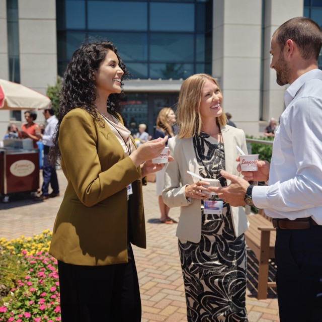 attendees outside convention center talking and eating ice cream