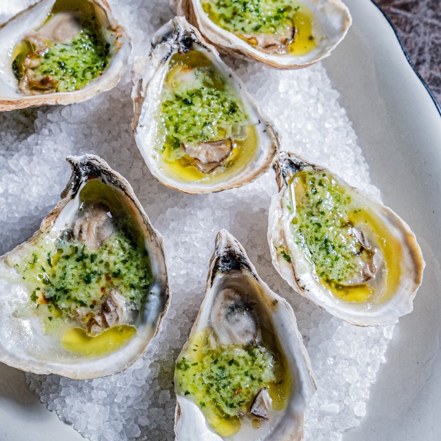 garlic roasted oysters on a bed of ice