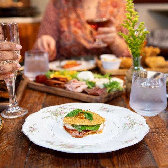 A dining table with plates of food.
