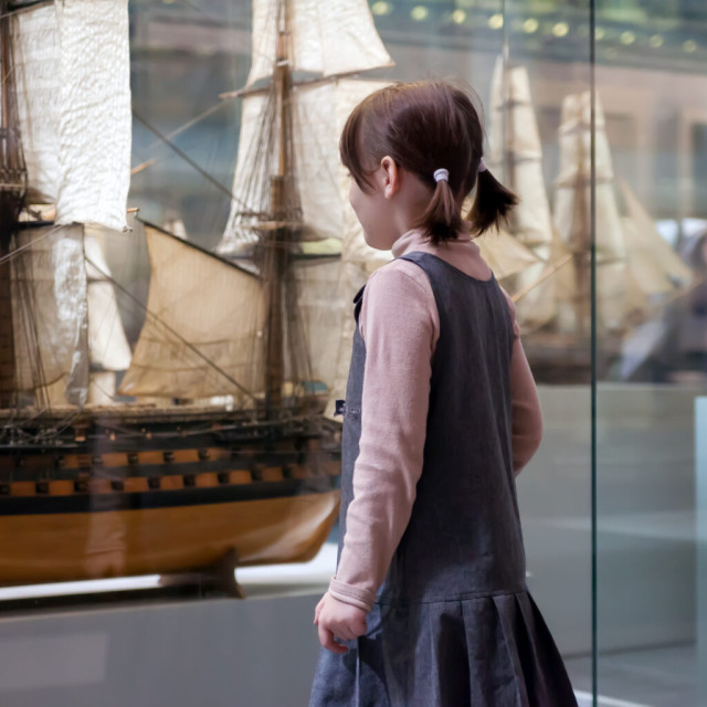 A child looking at exhibits in a museum.