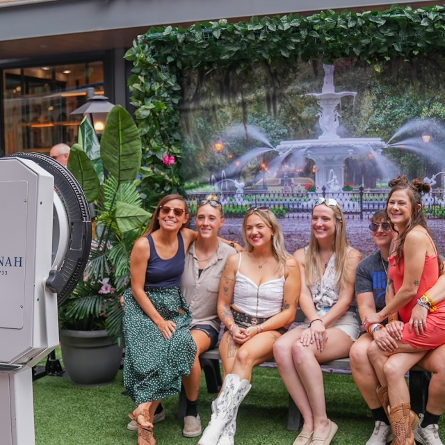 a group of friends at a photobooth