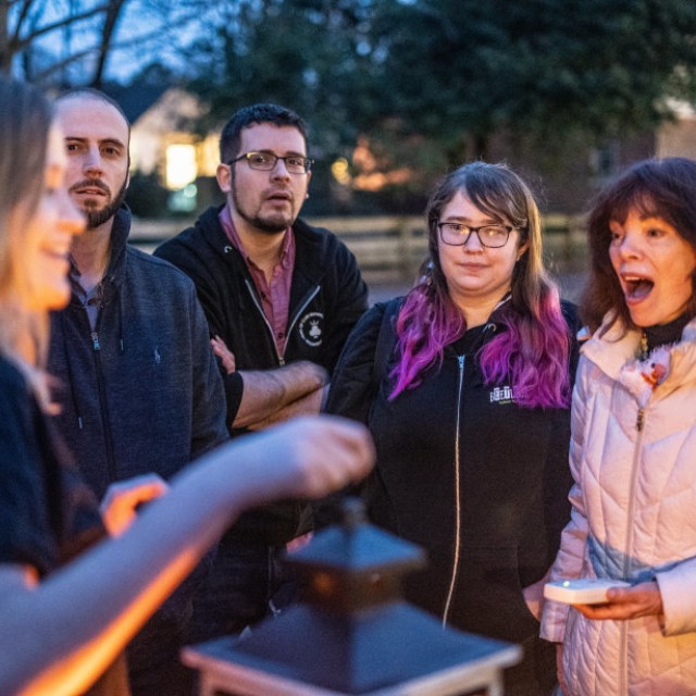 A group of people during an outdoor ghost tour.