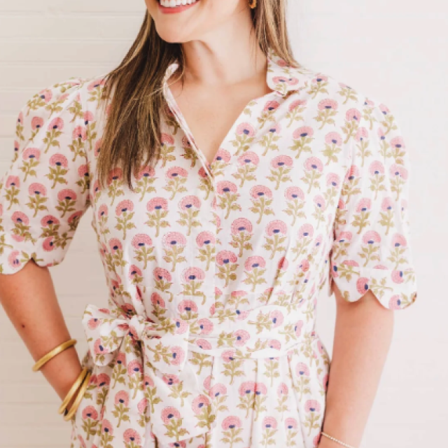 A woman posing and modeling a dress. 