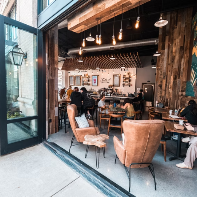 A riverside coffee shop with opened double doors.
