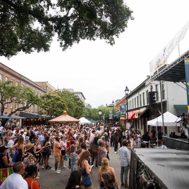 A large crowd of people enjoying an outdoor festival.