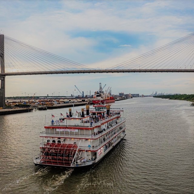 Riverboat cruise in Savannah traveling under a bridge.