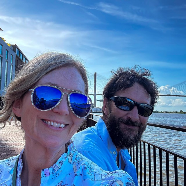 A couple posing on River Street in Savannah, GA.