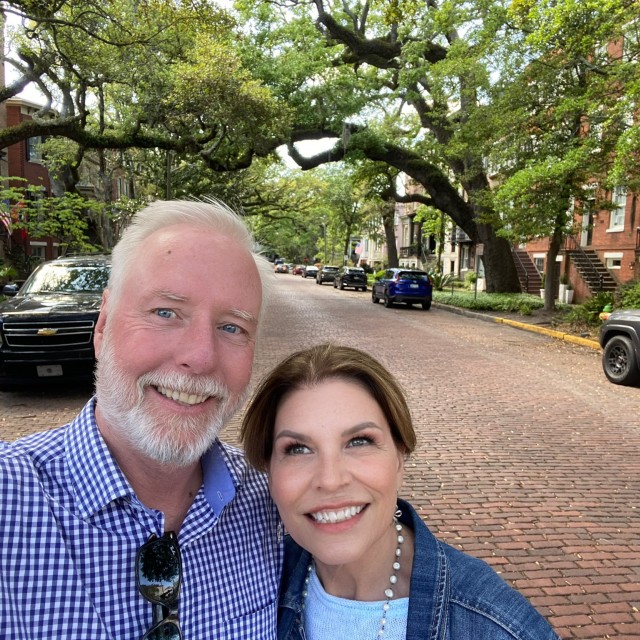 A couple taking a photo on Jones Street in Savannah, GA.