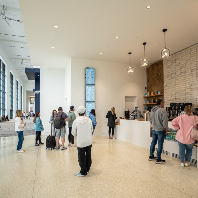 People utilizing the food and beverage stations inside the Savannah Convention Center.