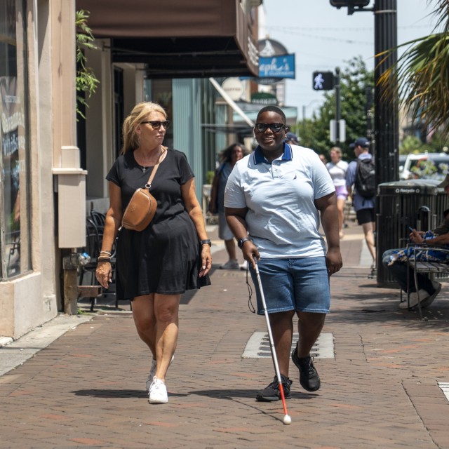 Blind walker and companion on Broughton Street