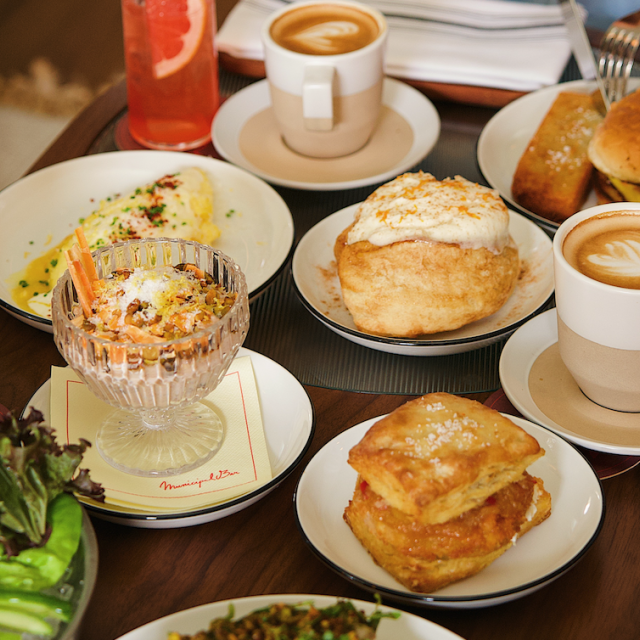 Municipal Bar brunch spread with lattes, cinnamon rolls, omlettes and drinks.
