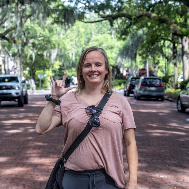 A woman that is deaf, posing for a photo on Jones St. Savannah, GA.