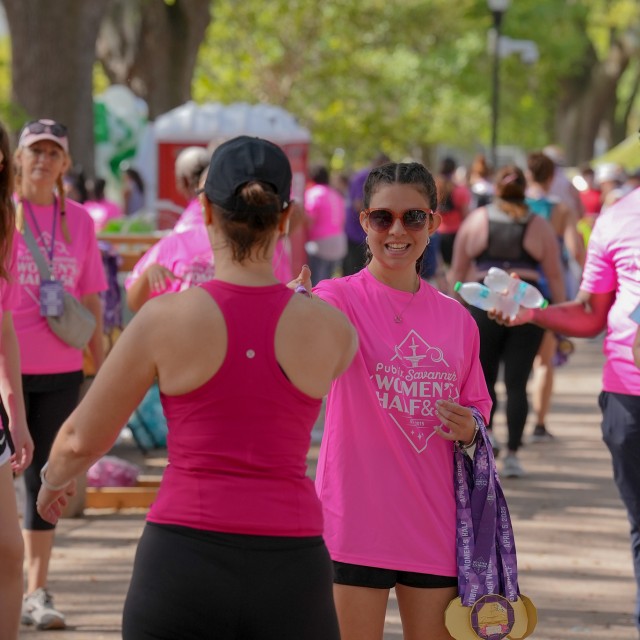 women handing out race medal