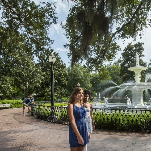 Two friends walking past the iconic Forsyth Park Fountain in Savannah, GA.