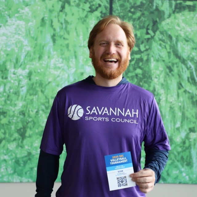 man smiling with handout