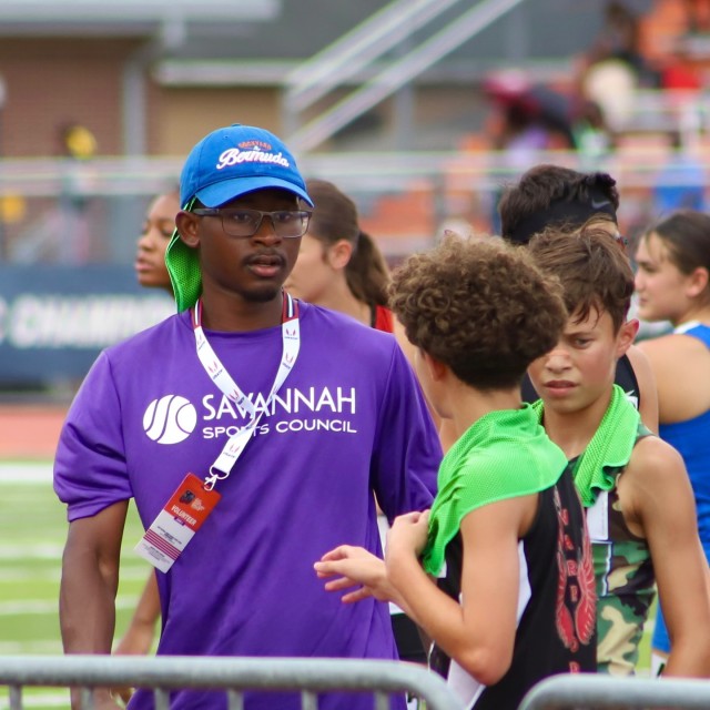 man talking to track and field athlete