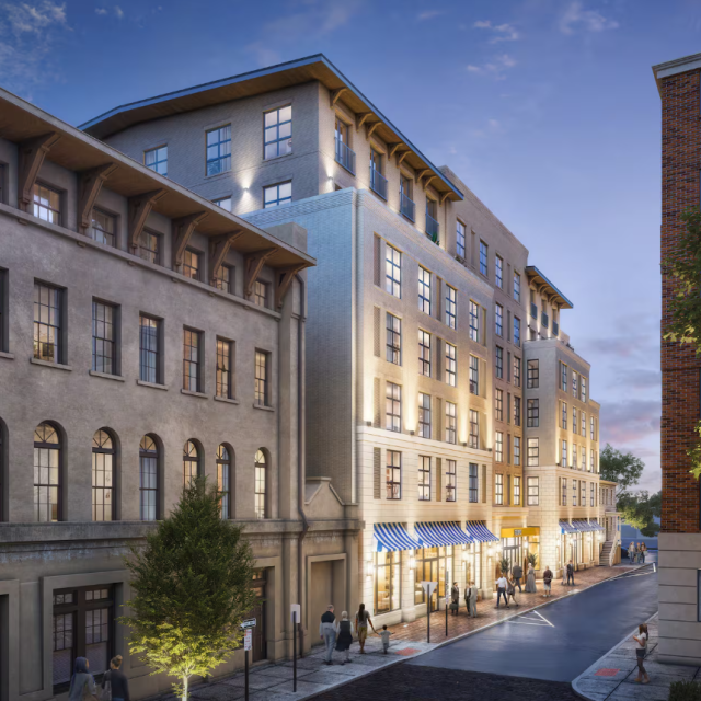Exterior rendering of Tempo by Hilton Savannah Historic District, showing a modern mid-rise hotel with illuminated windows, street-level storefronts, and pedestrians walking along a city street at dusk.