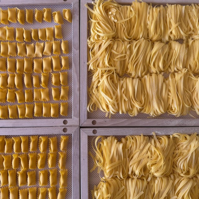 Fresh handmade pasta drying on wooden trays at Lucia Pasta Bar in Savannah.