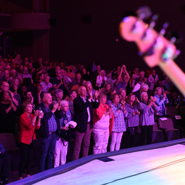 Audience standing and applauding during live performance at Savannah Music Festival in Savannah, GA.
