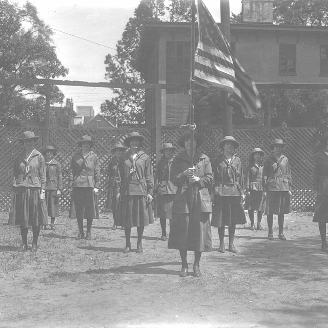 Historic Girl Scouts participating in a flag ceremony at the Andrew Low House in Savannah.