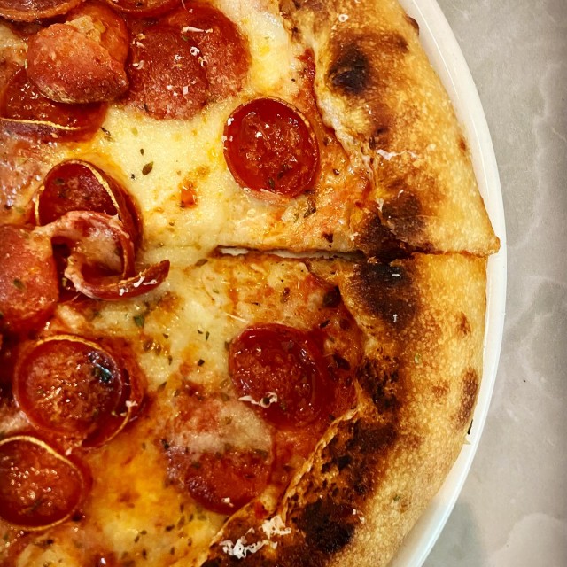 A side view of a pepperoni pizza at Veratina.