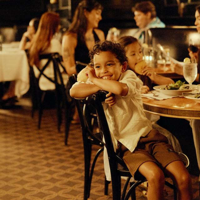Two children enjoy dinner with their family at a restaurant in Savannah.