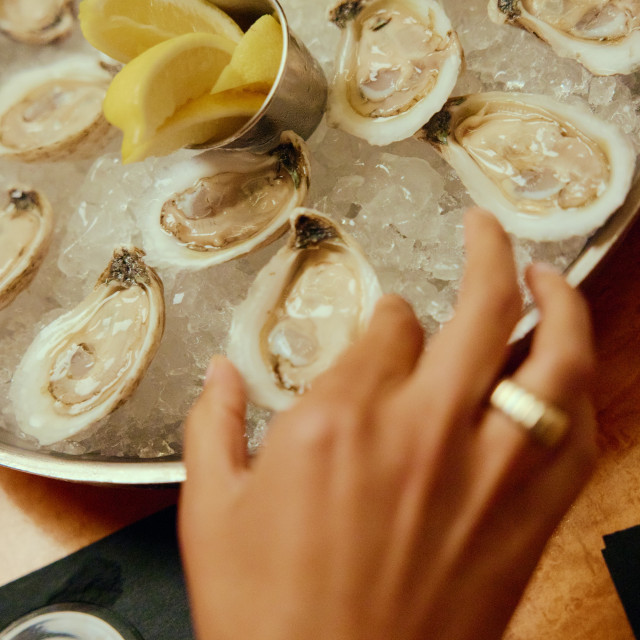 Fresh oysters and lemon wedges are served over ice at a Savannah restaurant.