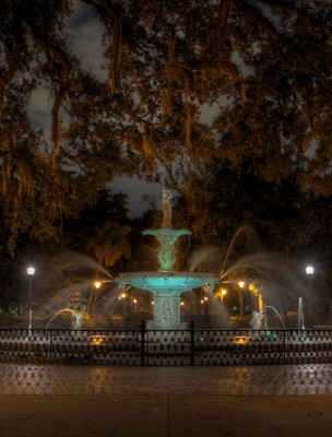 An eerie view of Forsyth Park at night