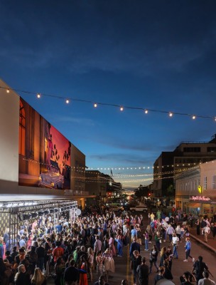 A large crowd gathered outside of a theatre for a film festival.
