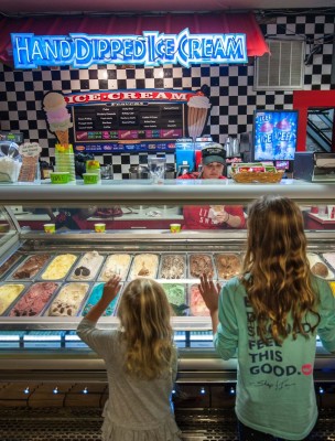 Kids looking at ice cream at River Street Sweets in Savannah, Georgia.