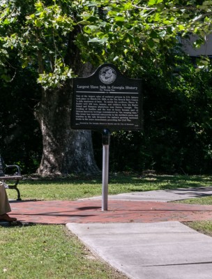 A man looks at The Weeping Time Historic Marker in Savannah, Georgia