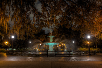 An eerie view of Forsyth Park at night