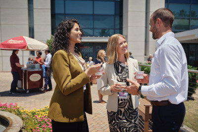attendees outside convention center talking and eating ice cream