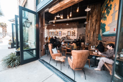 A riverside coffee shop with opened double doors.