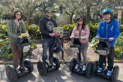 A group posing for a photo on segways with Adventure Tours in Motion