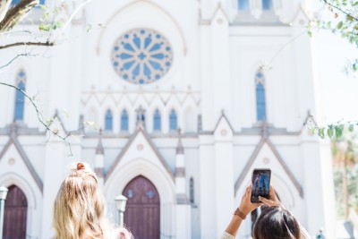 Visitors snap photos of the Cathedral of St. John the Baptist