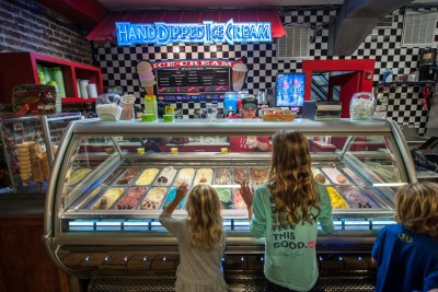 Kids looking at ice cream at River Street Sweets in Savannah, Georgia.