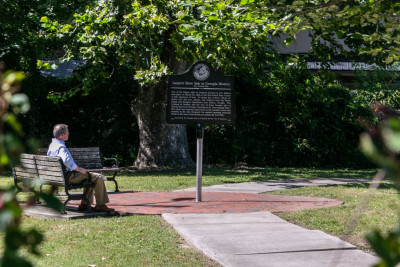 A man looks at The Weeping Time Historic Marker in Savannah, Georgia