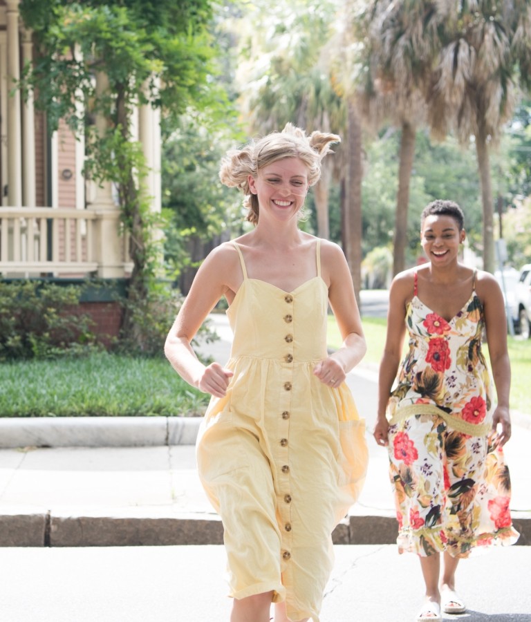 Two friends running through Savannah’s Victorian District neighborhood.