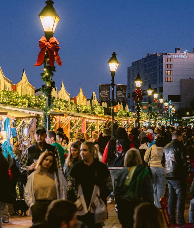 An outdoor Christmas Market with vendors along the Savannah River.