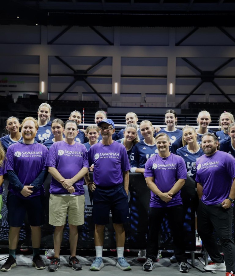 volunteers posing with athletes