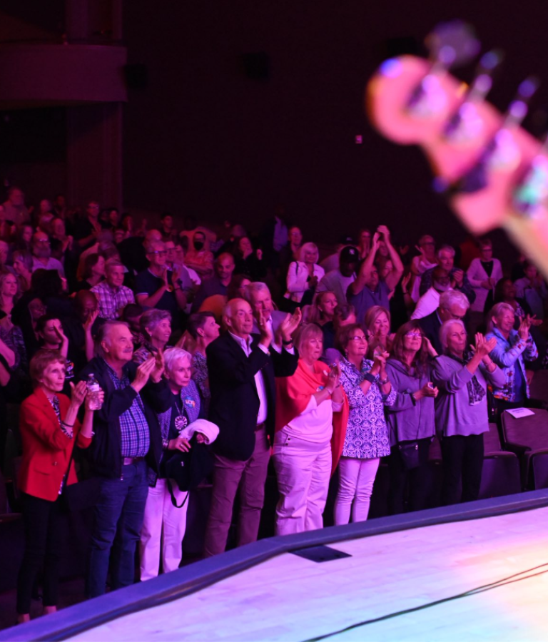 Audience standing and applauding during live performance at Savannah Music Festival in Savannah, GA.