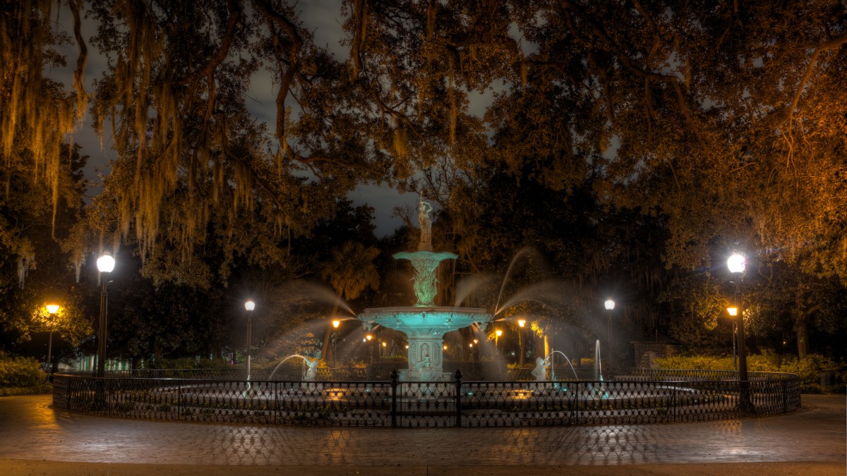 An eerie view of Forsyth Park at night