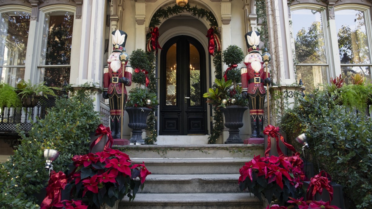 Exterior of a grand Savannah home draped in holiday decor.