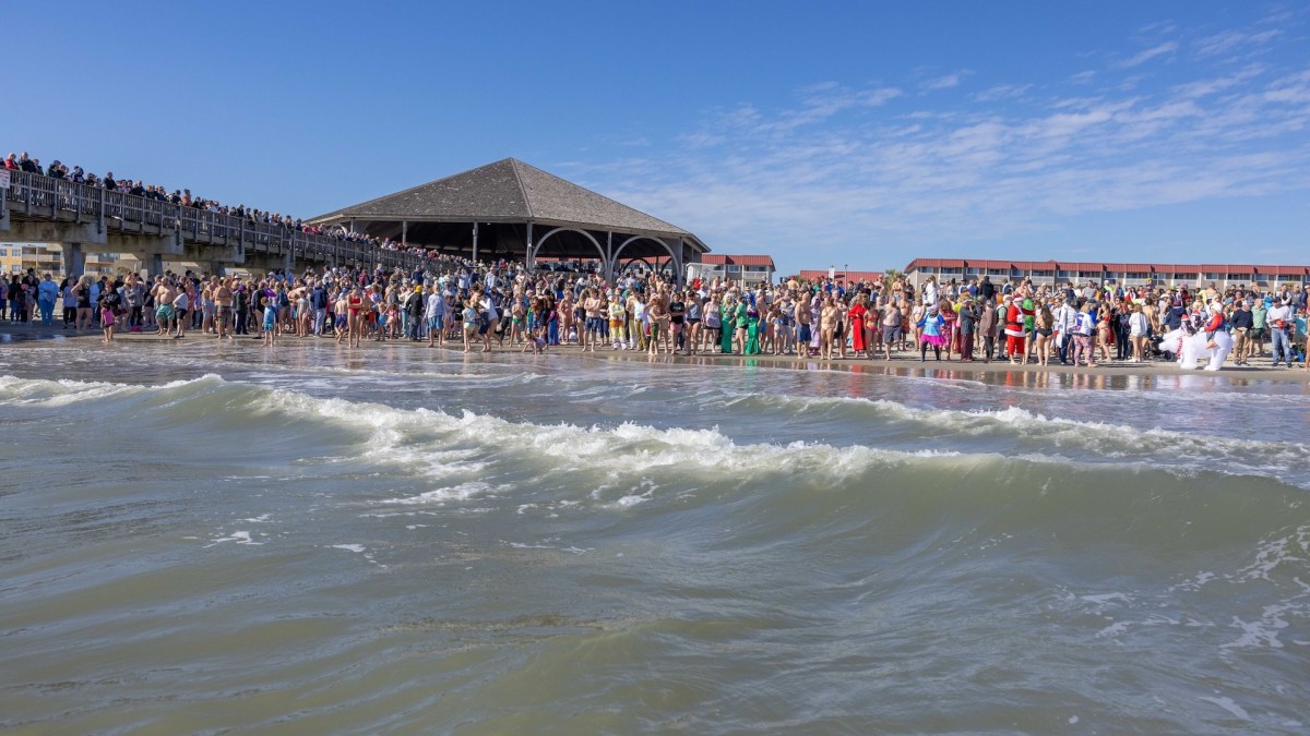 Crowd of people running into the ocean on Tybee Island
