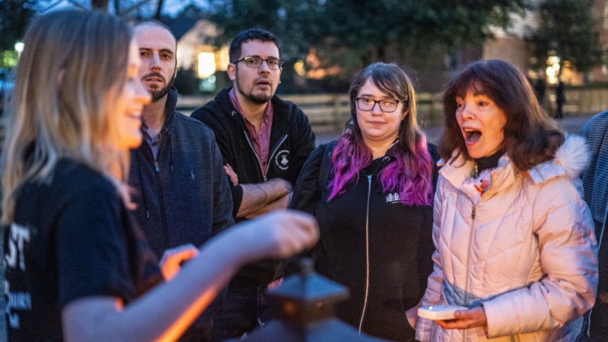 A group of people during an outdoor ghost tour.