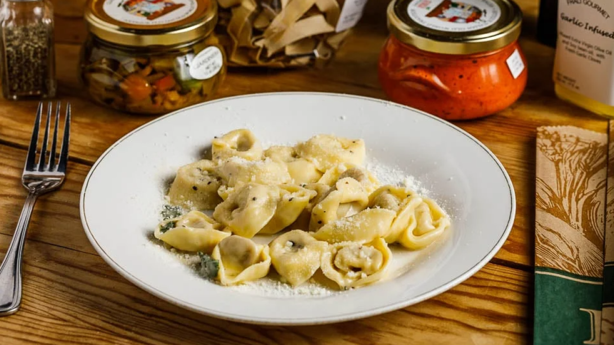 Tortellini served on a white plate.