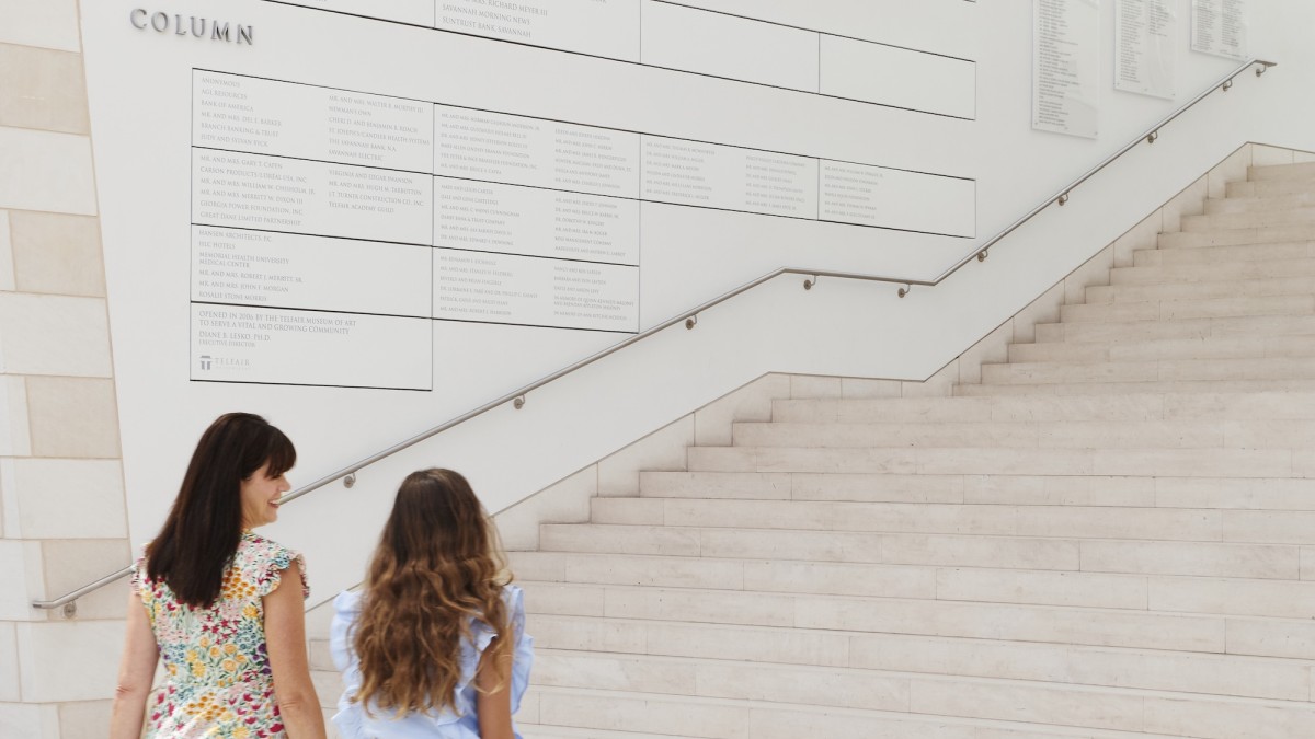 Two ladies walking towards the steps of a museum.