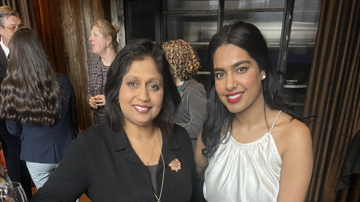 Two ladies posing for a picture.